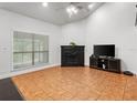 Cozy living room featuring a fireplace, neutral walls, and large windows for ample natural light at 940 Douglas Ave # 118, Altamonte Springs, FL 32714