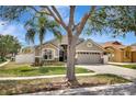Inviting single-Gathering home with a lush lawn, mature trees, and a welcoming two-car garage at 11209 Taeda Dr, Orlando, FL 32832