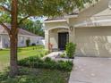 Well-maintained front yard featuring a charming home, lush landscaping, and a welcoming entrance at 116 Hurst Ct, Deland, FL 32724