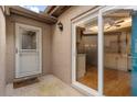Inviting entryway with sliding glass door, showing a glimpse into the well-lit kitchen and a white paneled front door at 121 Teriwood St, Fern Park, FL 32730