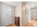 Bright foyer with hardwood floors, featuring a decorative front door, mirrored wall and hallway at 121 Teriwood St, Fern Park, FL 32730