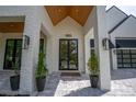 Inviting entrance with a striking front door, modern lighting, and decorative landscaping at 1220 Delaney Park Dr, Orlando, FL 32806