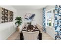 Contemporary dining room with an elegant table setting, stylish decor, and ample natural light at 1222 Alstonia Ln, Mount Dora, FL 32757