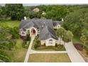 Expansive aerial view of a luxurious residence featuring mature landscaping, and a well-maintained driveway at 1709 Iverness Ct, Longwood, FL 32779