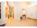 Bright foyer with tile flooring, high ceilings, elegant lighting, and a decorative window at 1709 Iverness Ct, Longwood, FL 32779