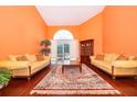 Spacious living room featuring hardwood floors, a large window, and comfortable seating at 1709 Iverness Ct, Longwood, FL 32779