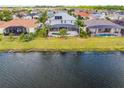 Aerial view of the back of the home featuring a screened in pool and lake view at 1712 Boat Launch Rd, Kissimmee, FL 34746