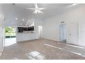 Bright living room featuring soaring ceiling and seamless flow into kitchen with breakfast bar at 205 Lori Ct, Umatilla, FL 32784