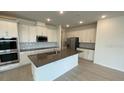 Modern, bright kitchen with stainless steel appliances, a large island, and ample cabinet space at 2152 Rock Maple Bnd, Kissimmee, FL 34746