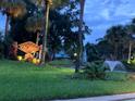 Community entrance sign surrounded by fountains and lush landscaping at twilight at 2155 Palm View Dr, Apopka, FL 32712