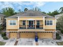 Inviting home featuring a balcony, well-manicured landscaping, and multi-car garages at 2256 Betsy Ross Ln, St Cloud, FL 34769