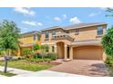 Inviting two-story home with a two-car garage and meticulously landscaped front yard at 2311 Victoria Dr, Davenport, FL 33837