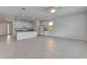 Expansive living space featuring tiled flooring, recessed lighting, ceiling fan, and open-concept kitchen at 2311 Victoria Dr, Davenport, FL 33837