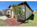 Well-maintained exterior with colorful flowerbed, offering great curb appeal and a two-car garage at 254 Alford Dr, Davenport, FL 33896