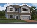Charming two-story home with blue siding, a stone-accented garage, and a well-manicured lawn at 2672 Great Heron Ave, St Cloud, FL 34773