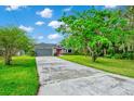 Beautiful single-story house featuring an extra long driveway, two-car garage, and manicured lawn at 275 W 3Rd St, Chuluota, FL 32766