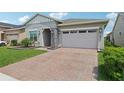 Charming single Gathering home featuring a well-manicured lawn and attached two-car garage at 2905 Tupelo Loop, St Cloud, FL 34772