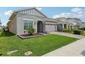 Charming single Gathering home featuring a well-manicured lawn and attached two-car garage at 2905 Tupelo Loop, St Cloud, FL 34772