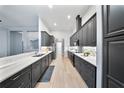 Modern kitchen with sleek dark cabinetry, stainless steel appliances, and stylish backsplash at 3281 Saloman Ln, Clermont, FL 34711