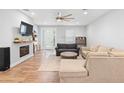 Bright living room featuring hardwood floors, fireplace, and modern furnishings for comfortable living at 34 Jackson Cir, Winter Springs, FL 32708
