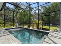 Relaxing screened-in pool with clear water, surrounded by lush greenery and providing a private oasis at 34 Jackson Cir, Winter Springs, FL 32708