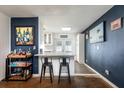 Modern bar area open to living room, featuring a sleek white countertop and stylish bar stools at 3511 E Crystal Lake Ave, Orlando, FL 32806