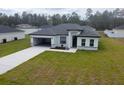 Inviting one-story home featuring a well-kept yard, gray accents, and a modern architectural design at 4634 Sw 170Th Road, Ocala, FL 34473