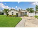 Well-maintained single-story home with a green lawn and a walkway to the entrance at 5345 Sunrise Blvd, Orlando, FL 32803