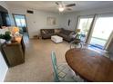 Comfortable living room featuring a sofa, ceiling fan, and sliding glass doors to the exterior at 573 N Atlantic Ave # 5, New Smyrna Beach, FL 32169