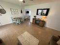 Inviting living room with coastal decor, a ceiling fan, and open layout to dining at 573 N Atlantic Ave # 5, New Smyrna Beach, FL 32169