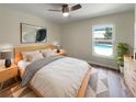 Comfortable bedroom with a ceiling fan, natural light, and views of the refreshing pool outside at 6740 Se 107Th St, Belleview, FL 34420