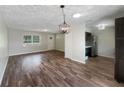 Open-concept living area with wood flooring, a dining area, and views into the updated kitchen at 6740 Se 107Th St, Belleview, FL 34420