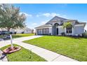 Charming single-story home with well-manicured lawn and a two car garage at 7606 Fordham Creek Ln, Orlando, FL 32818