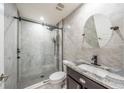 Modern bathroom with a glass-enclosed shower, decorative tile, and sleek vanity at 828 Gisele Ct, Haines City, FL 33844