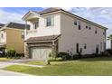 Two-story home featuring multiple vertical windows and a stone-accented garage at 834 Golden Bear Dr, Reunion, FL 34747