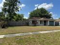 Classic single-story house has a charming front yard with mature trees and a private driveway at 871 Darwin Dr, Altamonte Springs, FL 32701