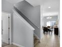 Hallway and staircase featuring neutral paint, white trim and tile flooring at 8971 California Palm Rd, Kissimmee, FL 34747