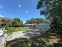 Inviting one-story home with a two-car detached garage and beautiful mature trees in the front yard at 12015 Se 72Nd Court Rd, Belleview, FL 34420