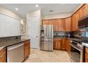 Modern kitchen boasts stainless steel appliances, custom cabinetry, and granite countertops at 122 Lower Lake Ct, Debary, FL 32713