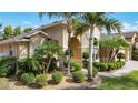 Beautiful home exterior with lush tropical landscaping, manicured shrubs, and a well-maintained lawn at 13139 Paloma Dr, Orlando, FL 32837