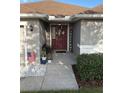 Inviting front entrance with decorative accents and a well manicured landscape at 1381 Woodlark Dr, Haines City, FL 33844
