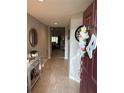 Warm foyer with a decorative console table, mirror and views into the home's living area at 1381 Woodlark Dr, Haines City, FL 33844