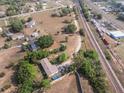 Aerial view of property featuring mature trees, well and a single-story home with backyard pool at 2300 Olsen Rd, Haines City, FL 33844