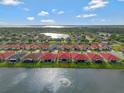 Stunning aerial view of a lakeside community with well-maintained homes and red tile roofs at 2335 Symphony Cir, St Cloud, FL 34771