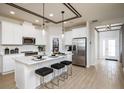 Bright, all-white kitchen features stainless appliances, tile backsplash, and wood-look flooring at 2547 Great Heron Ave, St Cloud, FL 34773