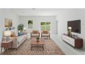 Inviting living room with stylish furniture, neutral tones, and abundant natural light at 2596 Sw 146 St, Ocala, FL 34473