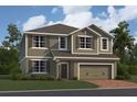 Charming two-story home featuring a welcoming front door, attached two car garage and manicured lawn at 2666 Great Heron Ave, St Cloud, FL 34773