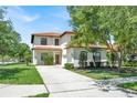 Charming two-story home with a well-manicured lawn, a red tile roof, and an attached two-car garage at 2840 Roccella Ct, Kissimmee, FL 34747