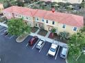 Aerial view of the townhome, parking lot, and lush landscaping at 3020 Red Ginger Rd, Kissimmee, FL 34747