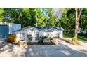 Charming home with mature trees, well-maintained landscaping, and a gravel driveway at 30542 Hoylake St, Sorrento, FL 32776